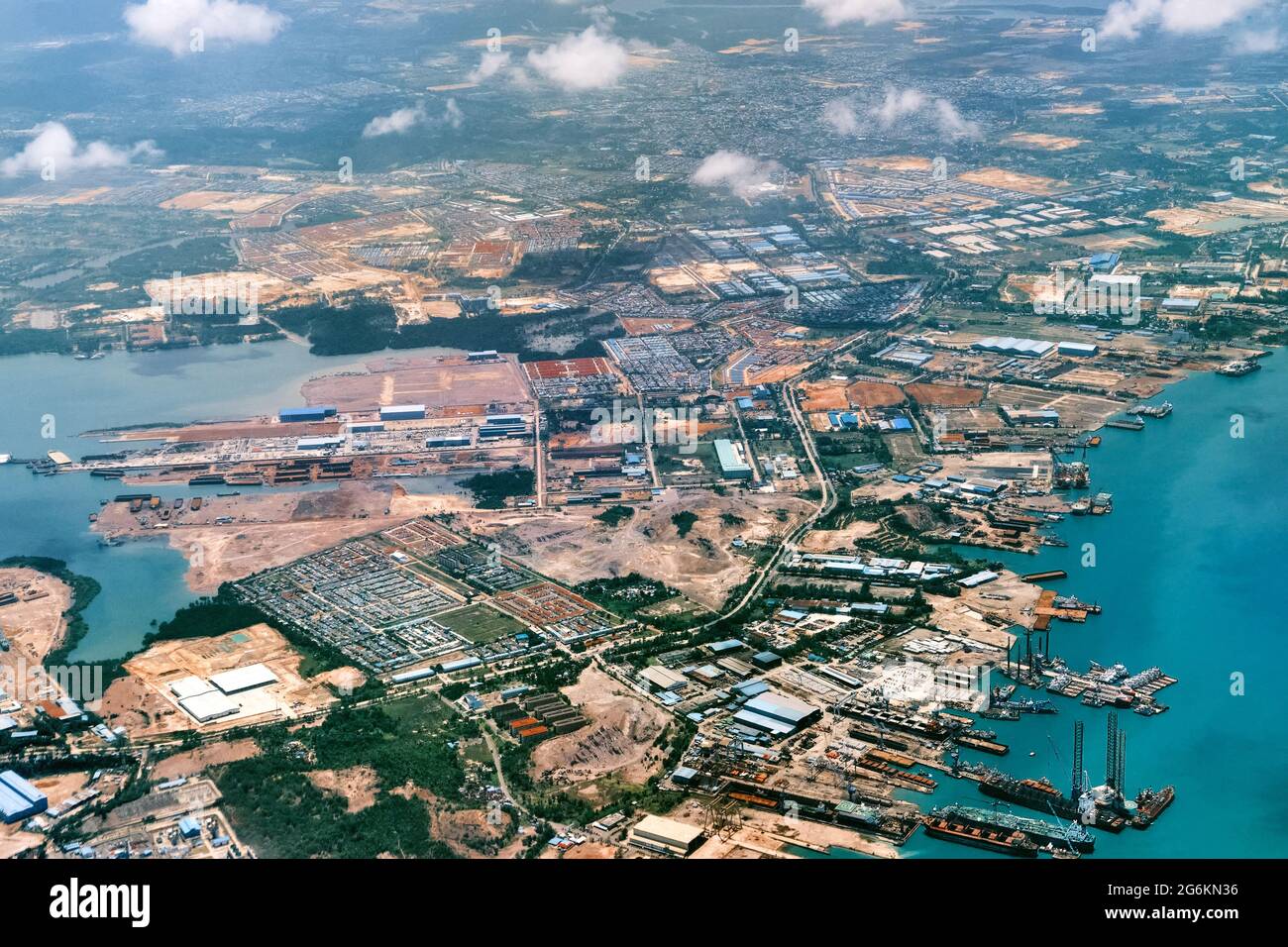 Aerial view of coastal construction or port areas in Strait of Malacca, on airplane route to Malaysia or Singapore. Airplane shot Stock Photo