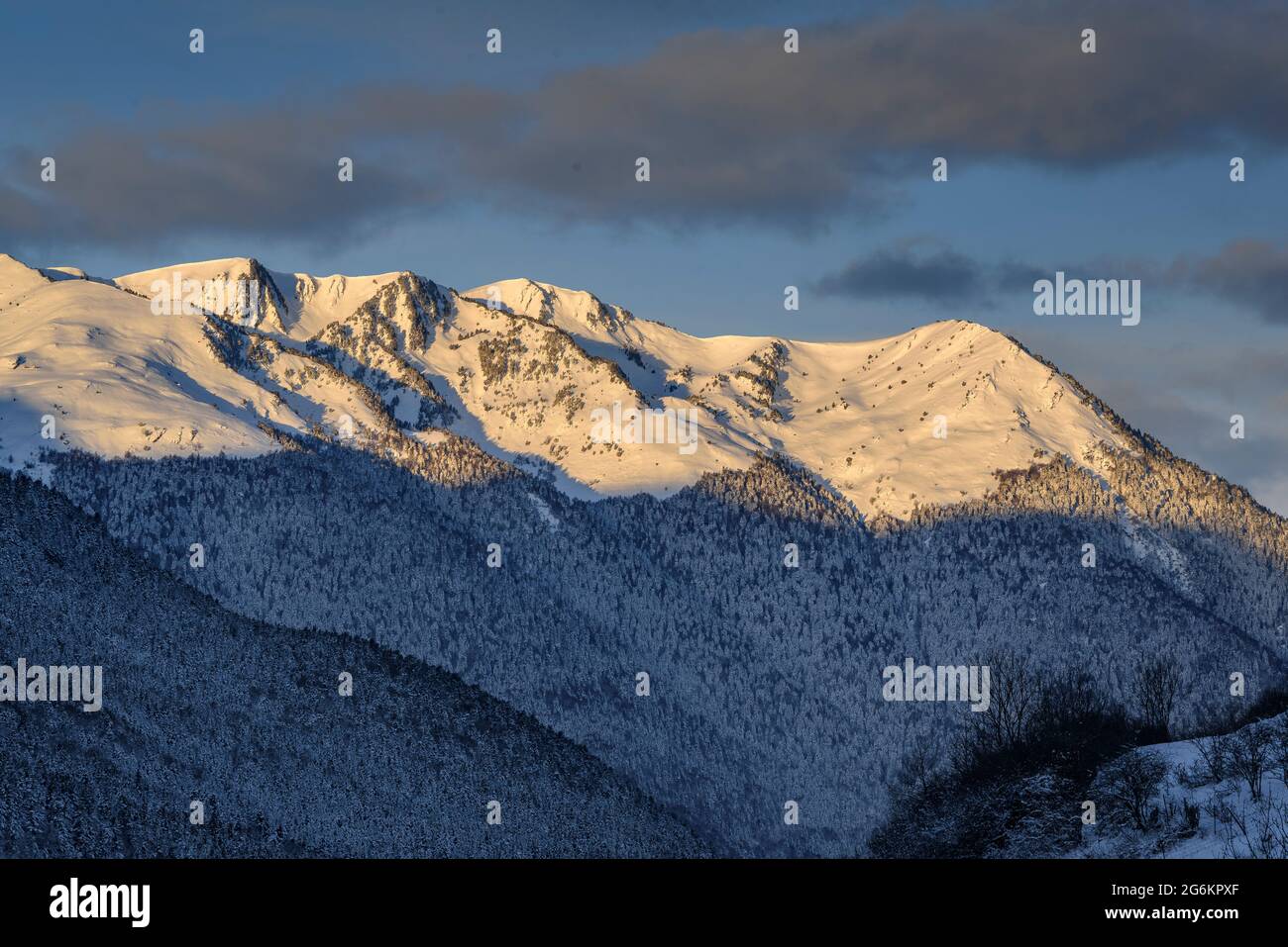 Aran Valley in a winter sunrise after a snowfall, seen from the village of Mont (Aran Valley, Catalonia, Spain, Pyrenees) Stock Photo