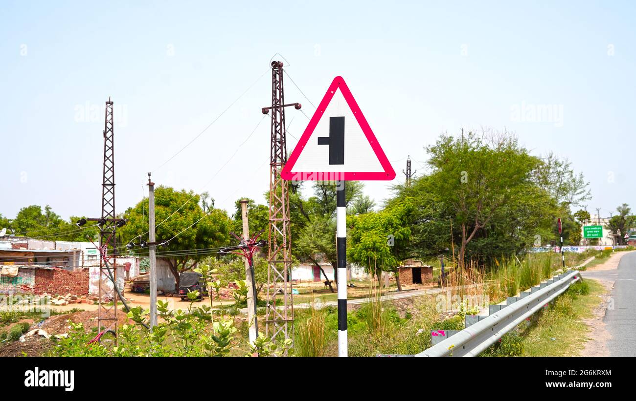07 July 2021- Reengus, Sikar, India. Asphalt road sign board to move left side. Indian traffic rules and regulations concept. Stock Photo