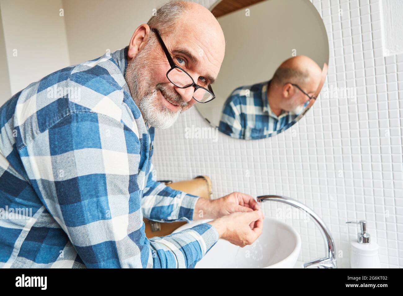 Craftsman as plumber repairing sink faucet in the bathroom Stock Photo Alamy