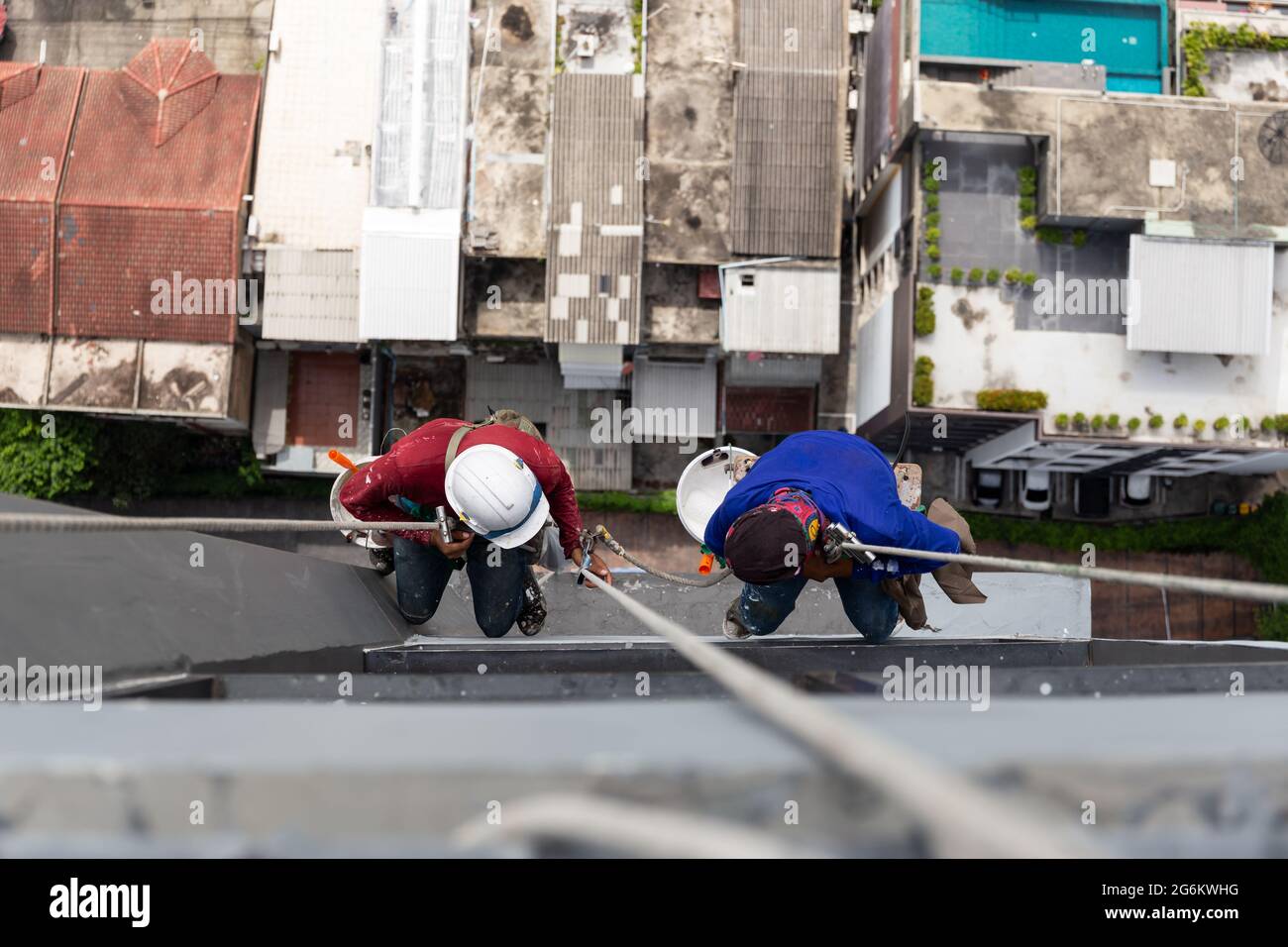 Asian Painters Hanging On Rope Painting Color On Building Wall Stock 
