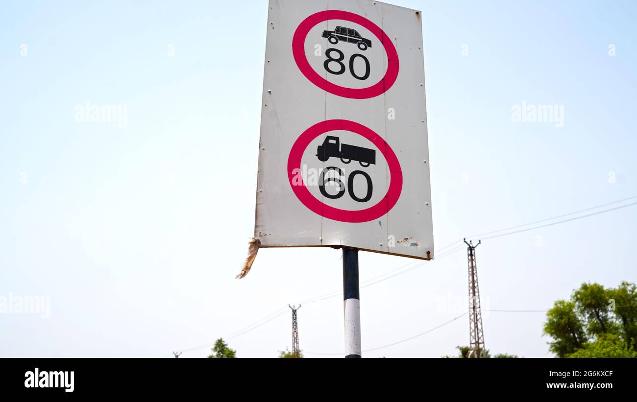 60 to 80 speed limit sign board along side the road. Maximum speed limit board closeup shot. Stock Photo