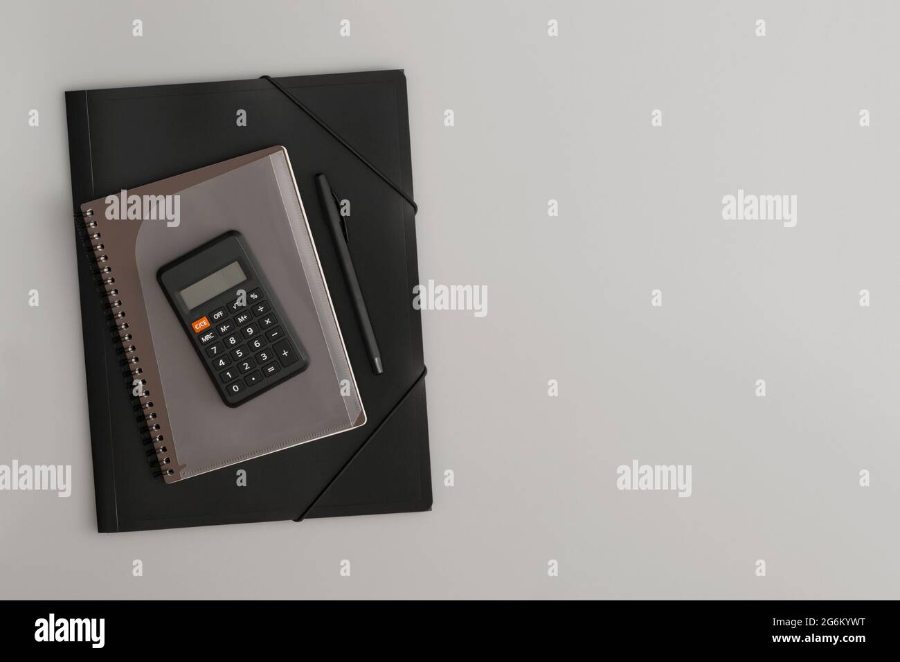 Calculator, notebook and pen on a white background Stock Photo