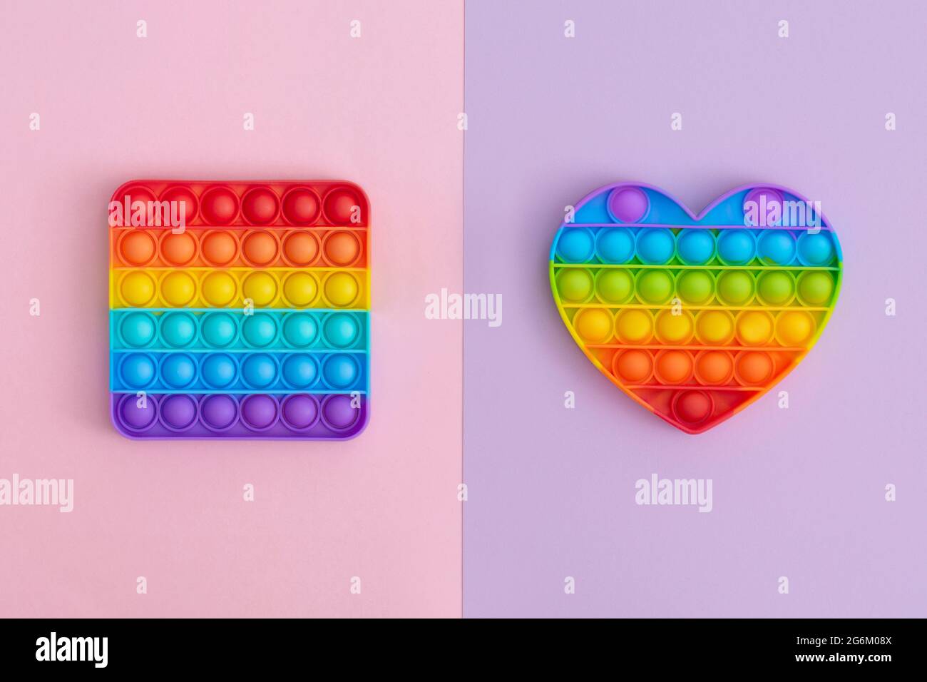 Colorful anti-stress pop it sensory toys for children on multicolored background. Stock Photo