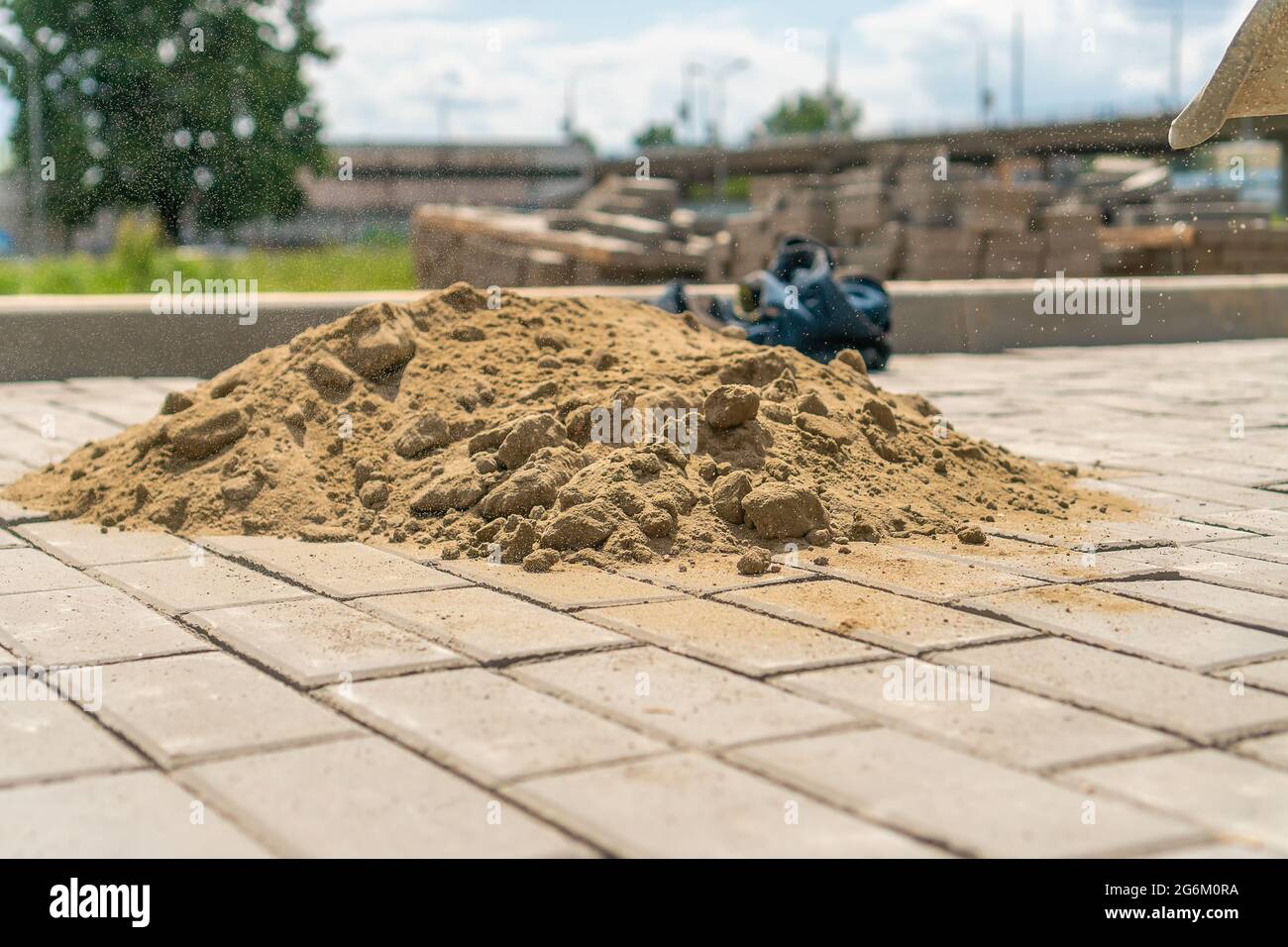 Closeup of a pile of sand lying on the new sidewalk to seal the seams
