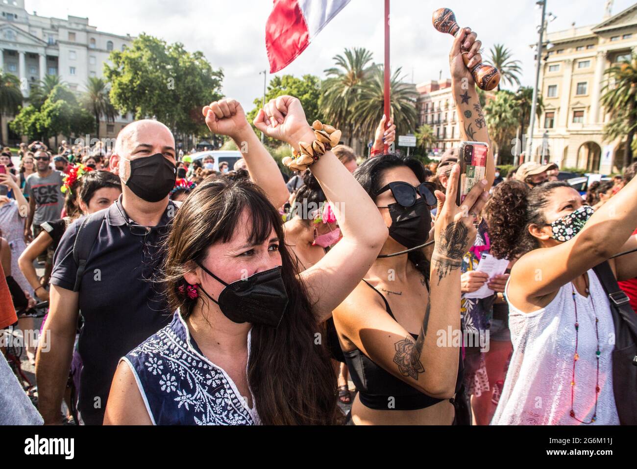 Barcelona, Catalonia, Spain. 6th July, 2021. People are seen with the fist up.Barcelona greets the 421 Squadron of the Zapatista Army of National Liberation (EZLN), a libertarian socialist political and militant group of Mexico, on their way through Europe. Composed of members known as Marijose, Lupita, Carolina, Ximena, Yuli, Bernal and Felipe, the 421 Squad has been received at the Columbus Monument by local collectives and social organizations. Credit: Thiago Prudencio/DAX/ZUMA Wire/Alamy Live News Stock Photo
