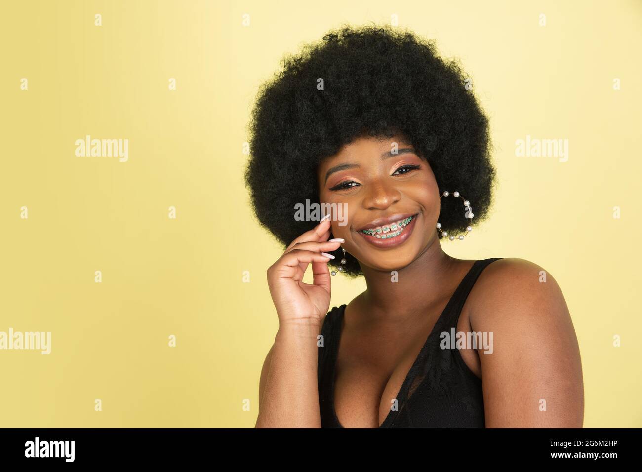 Close-up portrait of happy African young woman isolated over light ...