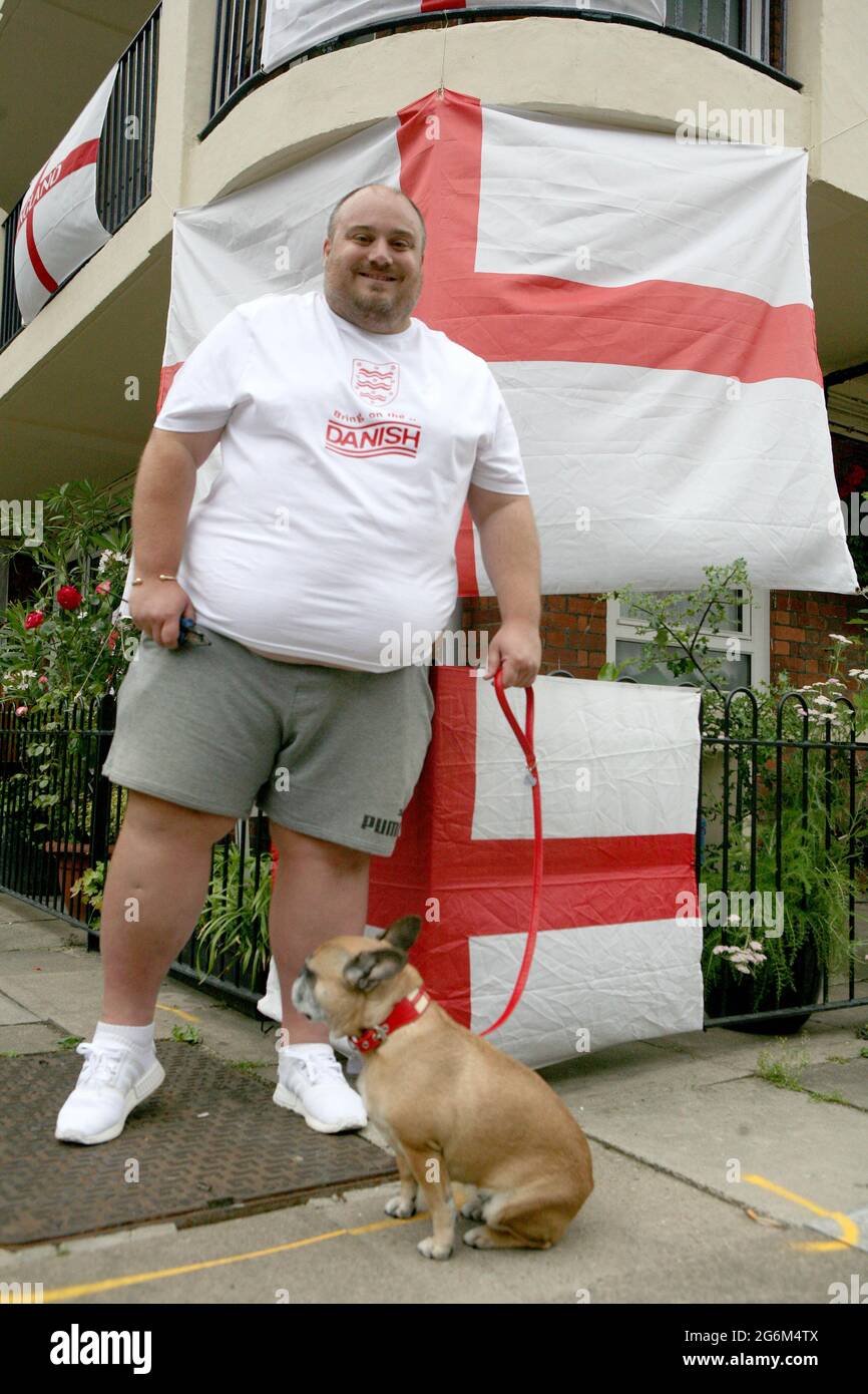 Resident Chris Dowse and his dog Tinkerbell on the Kirby Estate in Bermondsey, south London, where residents are showing their support for England ahead of their game against Denmark at Wembley on Wednesday evening in the second semi-final of Euro 2020. Picture date: Wednesday July 7, 2021. Stock Photo