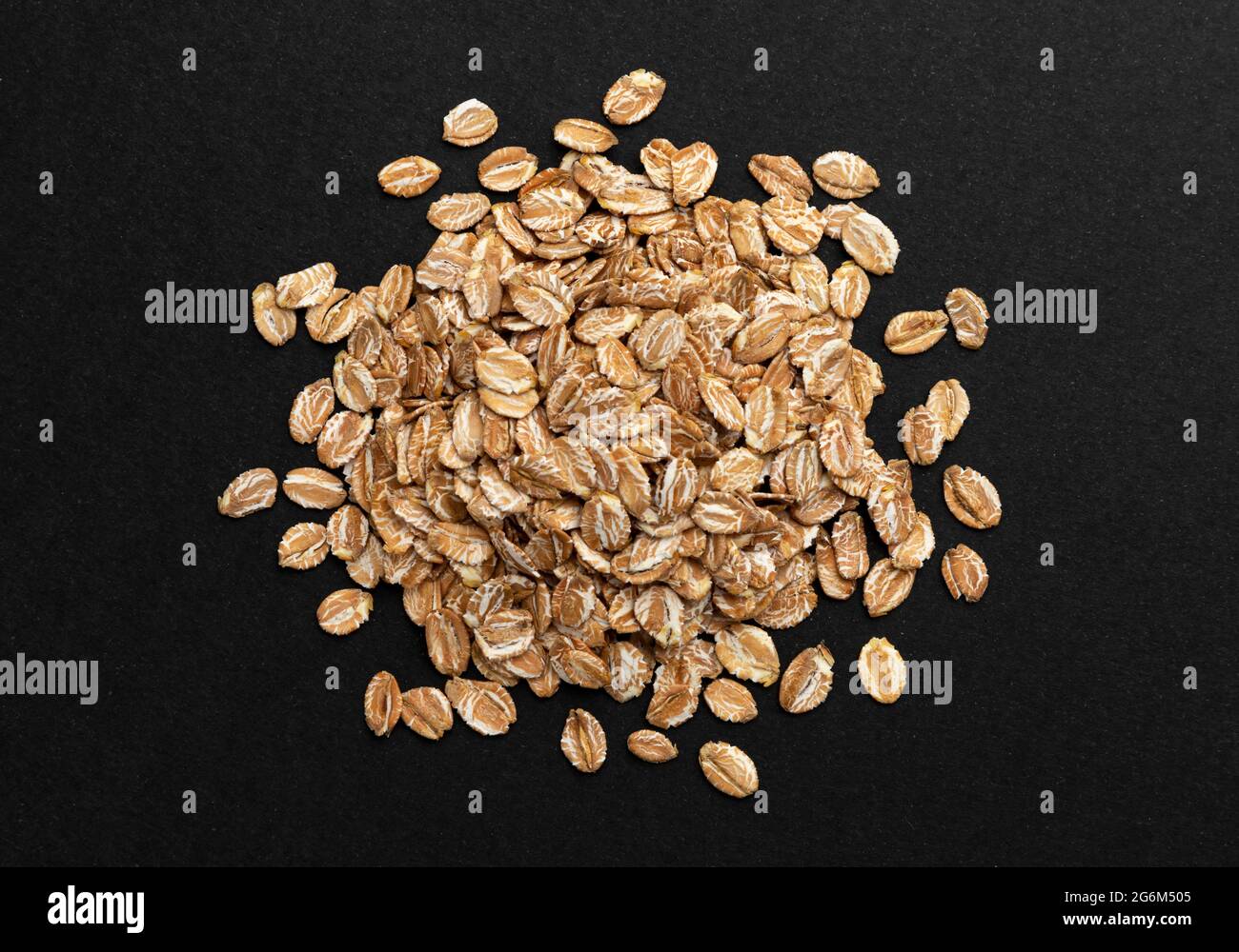 Top view of oat flakes on black background Stock Photo