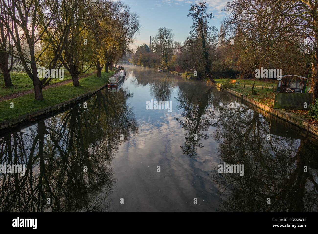 Pretty autumn view of the River Cam near Stourbridge Common with reflections and boats moored along the riverbank Stock Photo