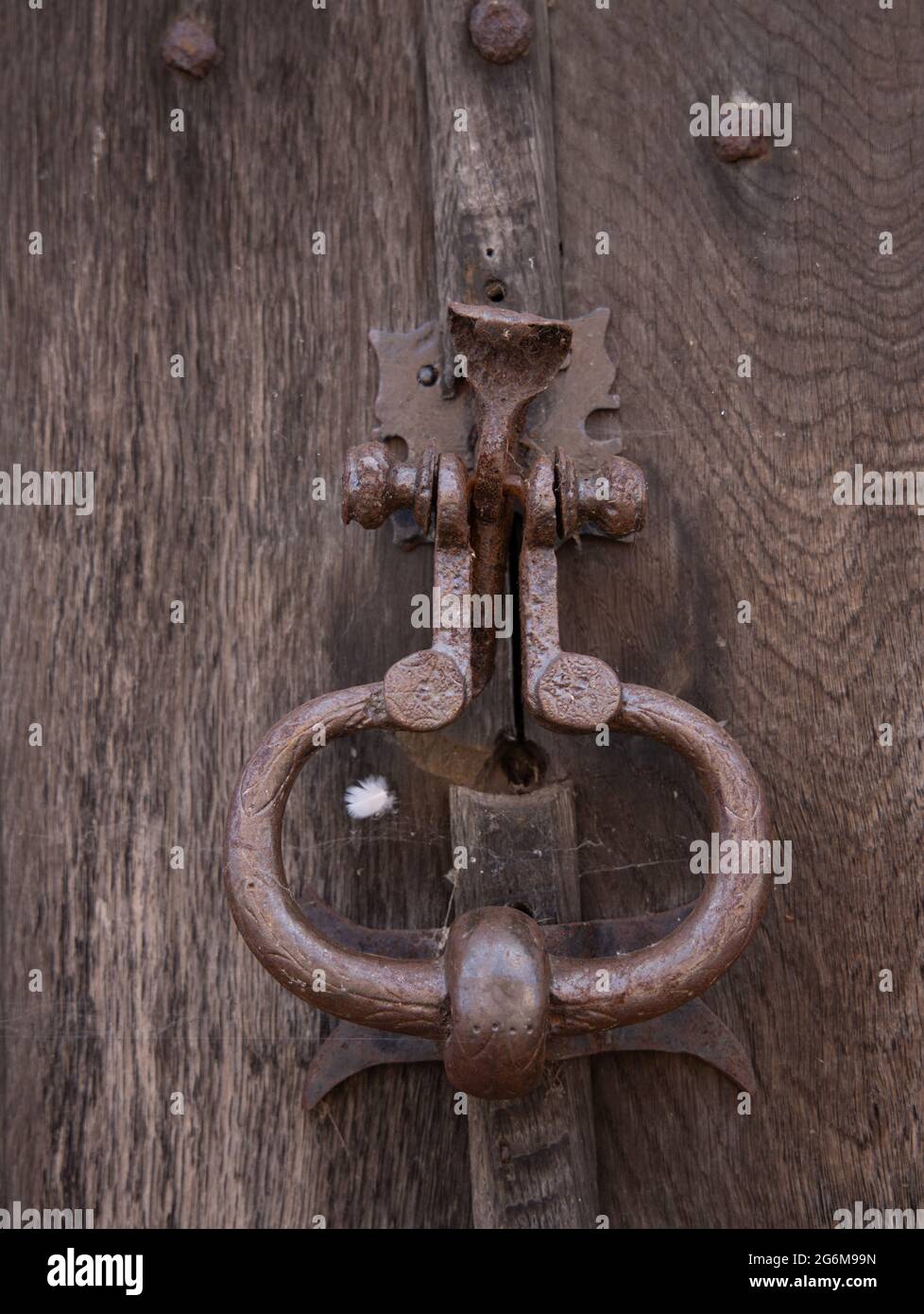 Closeup of old metal door knocker and latch on a wooden door Lavenham Suffolk England Stock Photo
