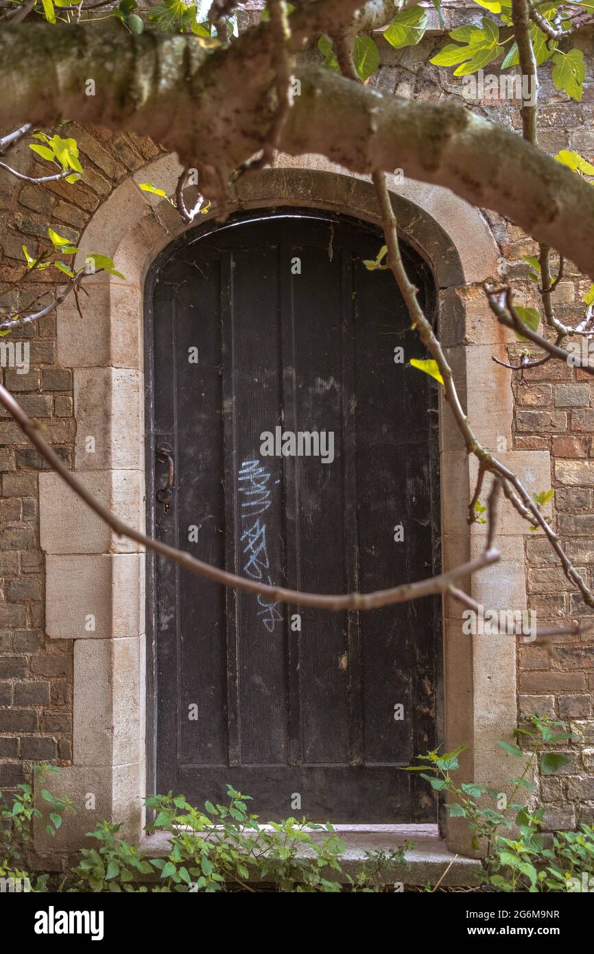 Hidden old door in old wall Cambridge England Stock Photo