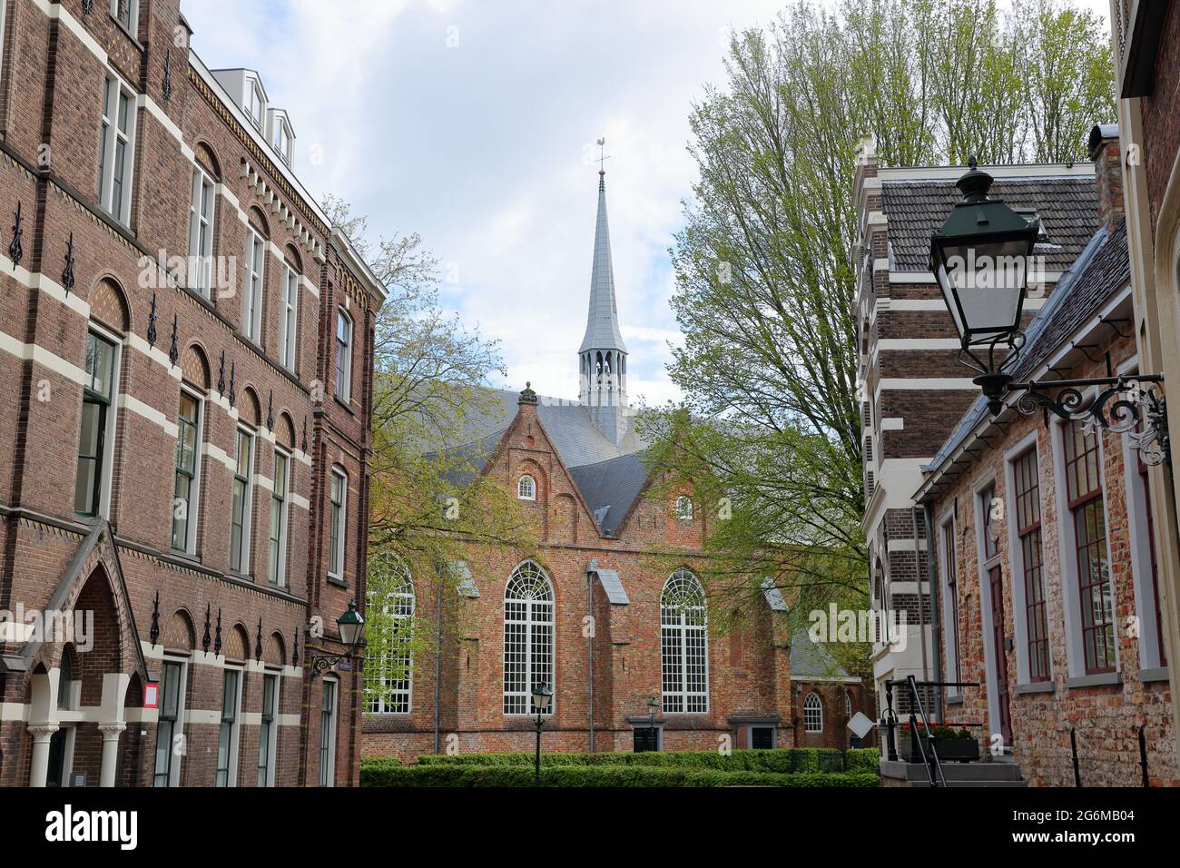 Jacobijnerkerk church viewed from Grote Kerkstraat street in Leeuwarden, Friesland, Netherlands, with historic buildings in the foreground Stock Photo