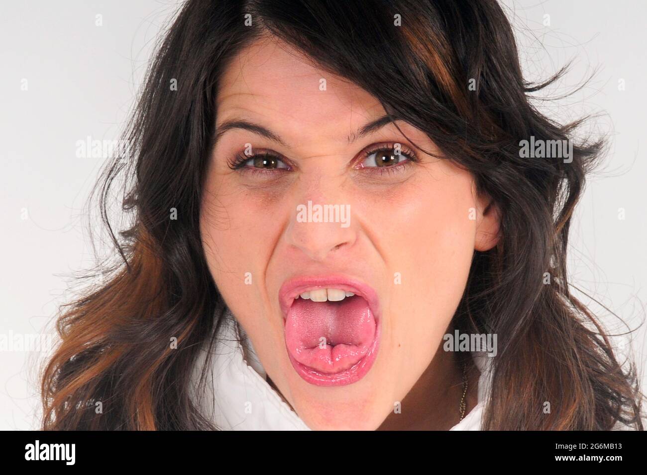Clover tongue or Upwards rolled tongue. Woman sticking her tongue out of her mouth, with the