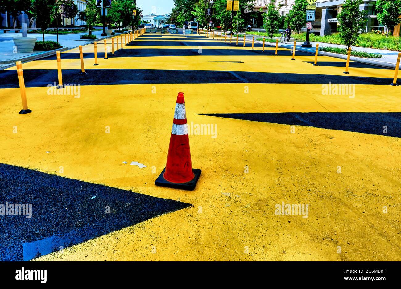 Black and yellow traffic barriers and markings on the street surface at Black Lives Matter Plaza in Washington D.C. Stock Photo