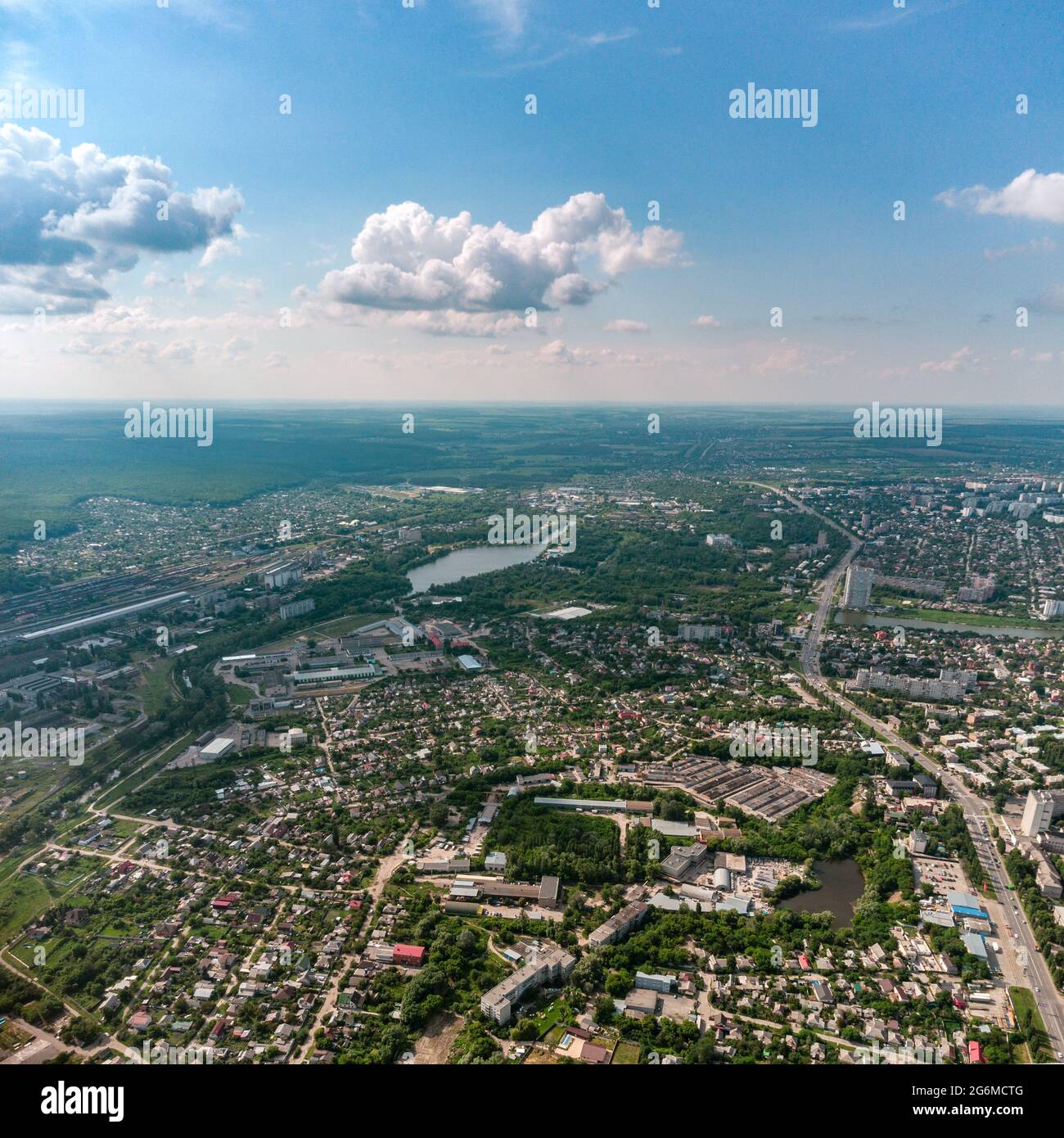 Aerial high view Kharkiv city Shevchenkivskyi district with Udy river, urban and residential multistory buildings with scenic colorful cloudy sky in s Stock Photo