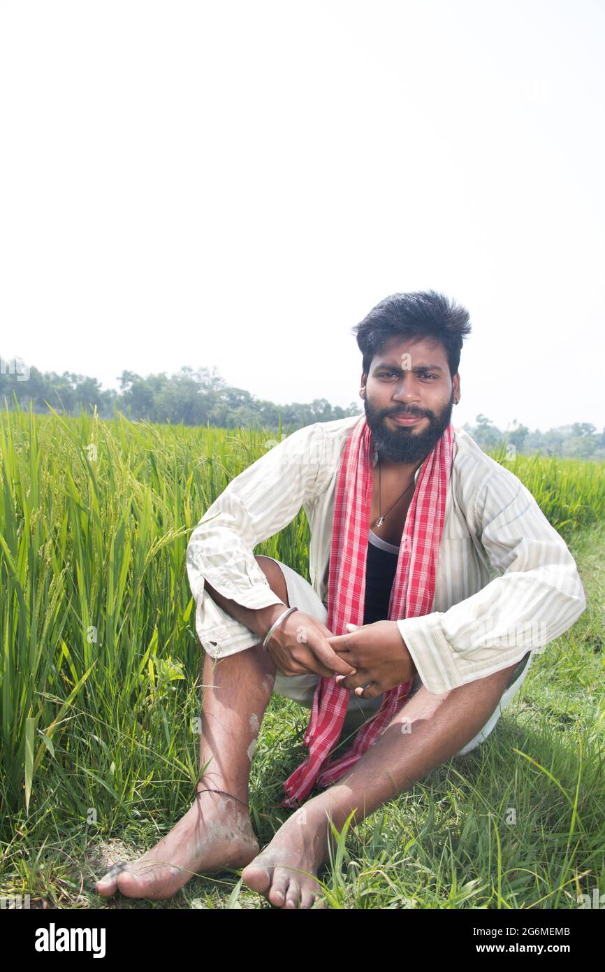Indian Young Rural Farmer Sitting in agricultural field Stock Photo - Alamy