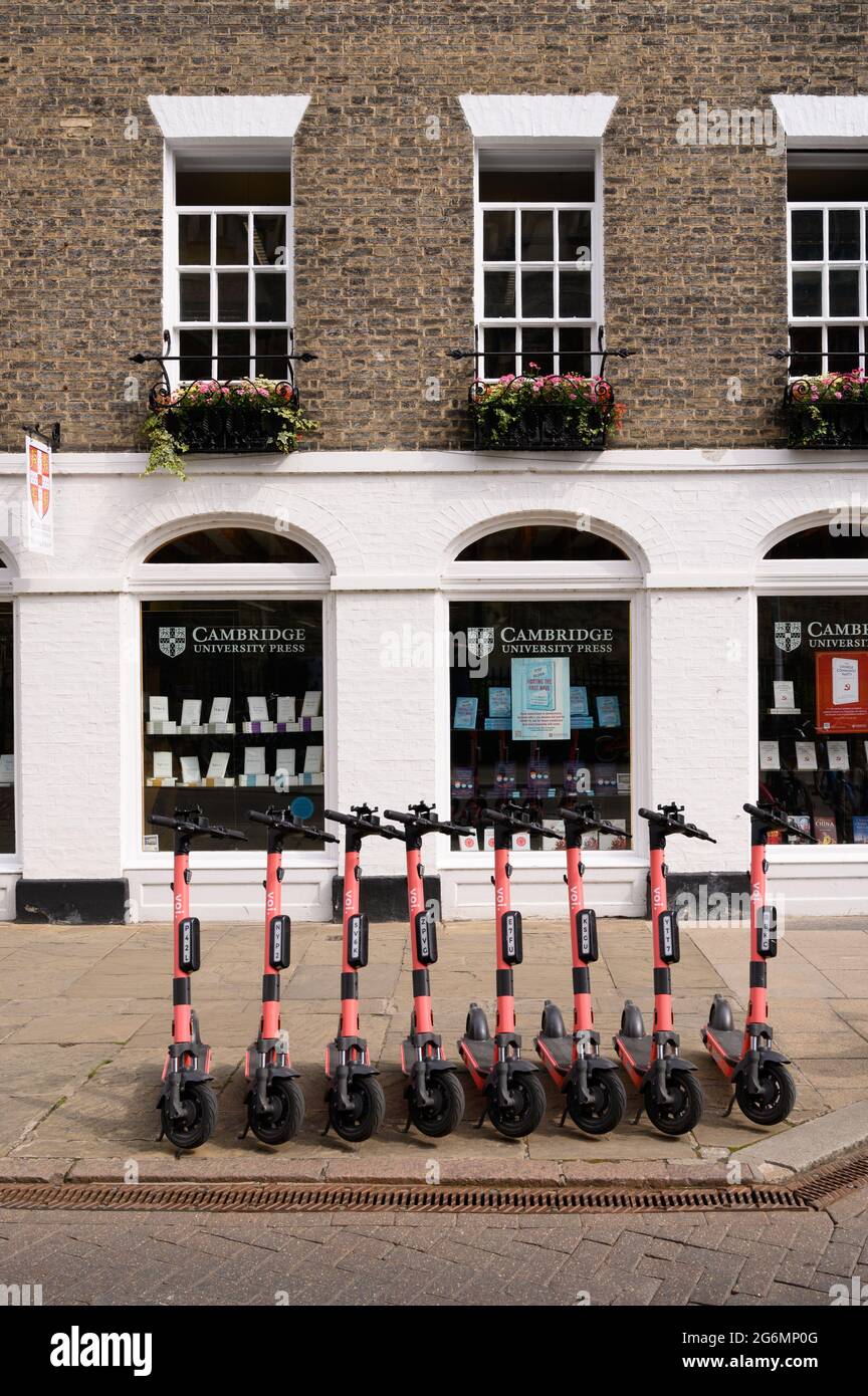 Electric hire scooters parked outside the Cambridge University Press Bookshop in Cambridge, England. Stock Photo