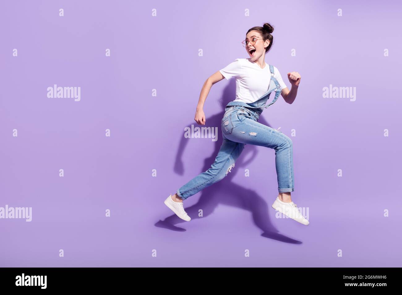 Full size profile side photo of young excited girl happy smile jump go ...