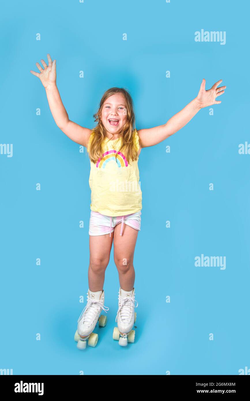 Cute attractive cheerful caucasian roller girl with quads skates