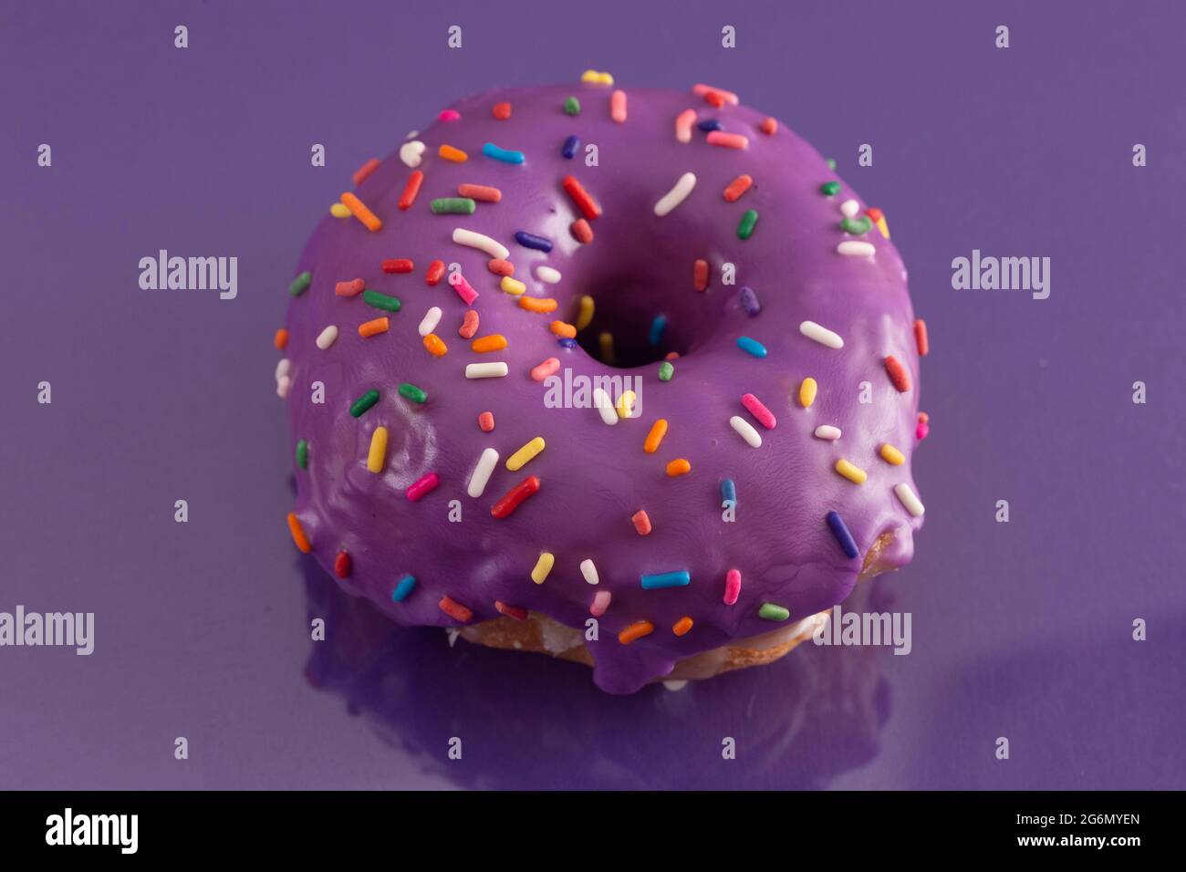 A Purple Glazed Donut with Rainbow Sprinkles on Top Stock Photo Alamy