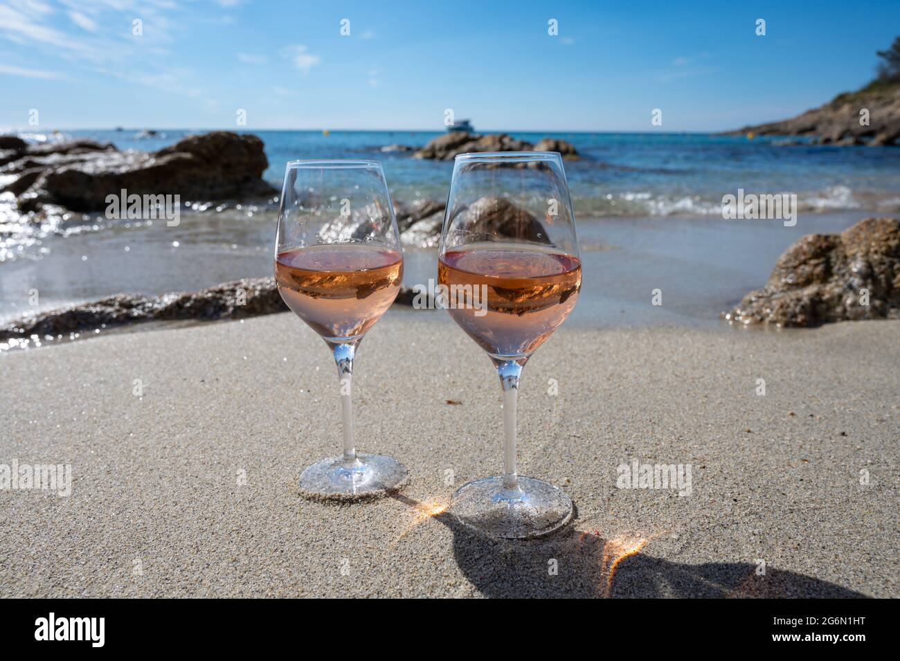 Summer time in Provence, two glasses of cold rose wine on sandy beach near Saint-Tropez in sunny day, Var department, France Stock Photo