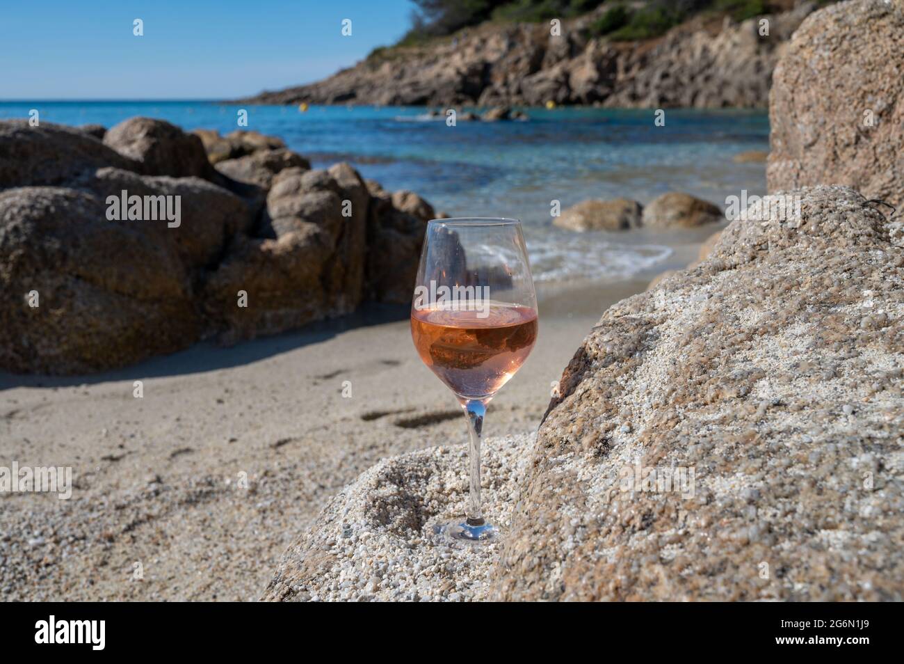 Summer time in Provence, glass of cold rose wine on sandy beach near Saint-Tropez in sunny day, Var department, France Stock Photo
