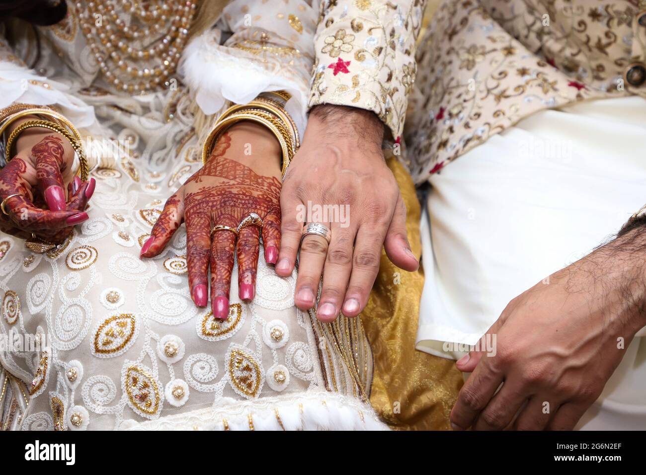 Newly wedding couple with a ring on their fingers. Asian wedding 