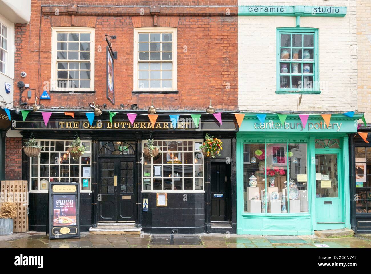 Pub and shops on the Butter Market Canterbury Kent England UK GB Europe Stock Photo