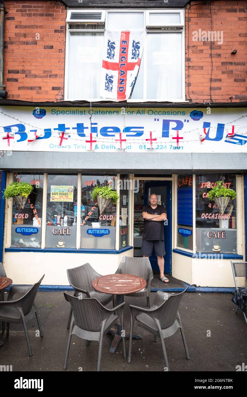 Manchester, UK. 07th July, 2021. Jeff stands outside his decorated shop, Butties R Us.Football fans decorate their houses and streets ahead of the England vs Denmark semi-final match. (Photo by Andy Barton/SOPA Images/Sipa USA) Credit: Sipa USA/Alamy Live News Stock Photo