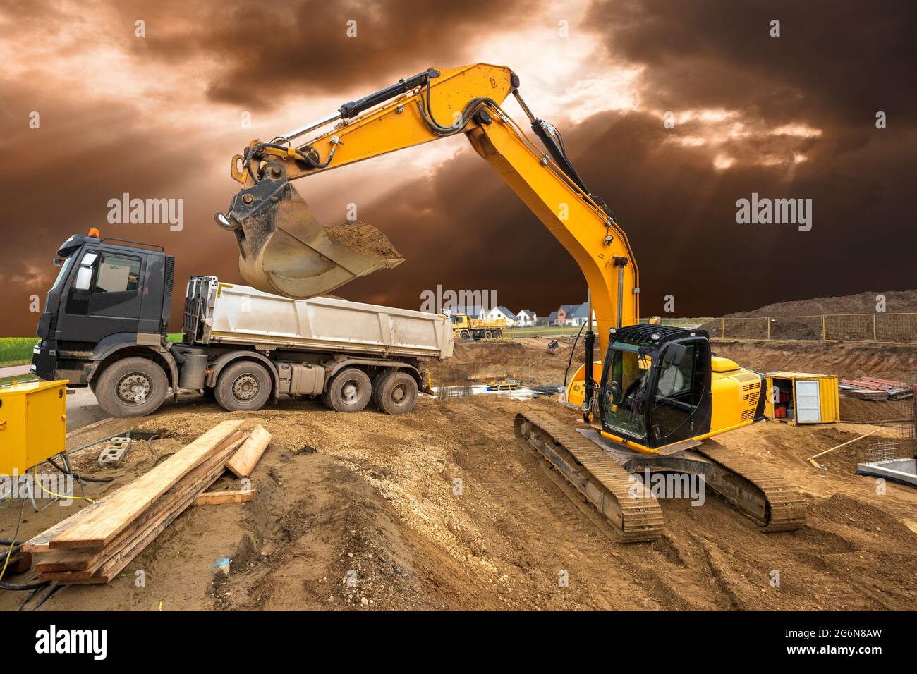excavator working on construction site with dramatic sky Stock Photo ...