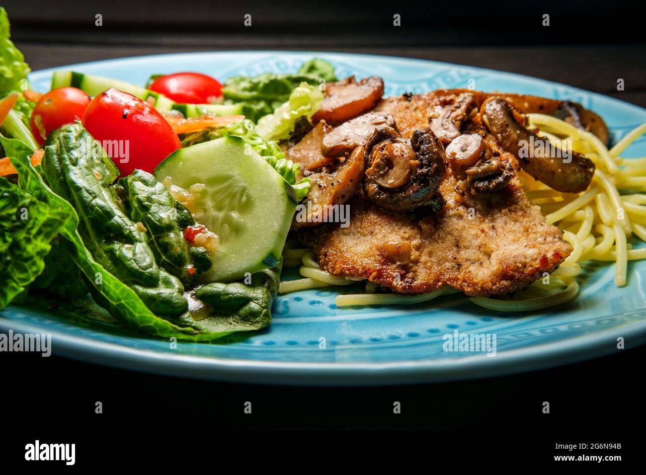 Italian veal marsala served over spaghetti with side garden salad Stock