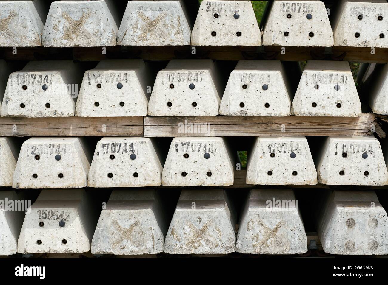 new numbered concrete railroad sleepers at the storage yard of a construction site in Magdeburg in Germany Stock Photo