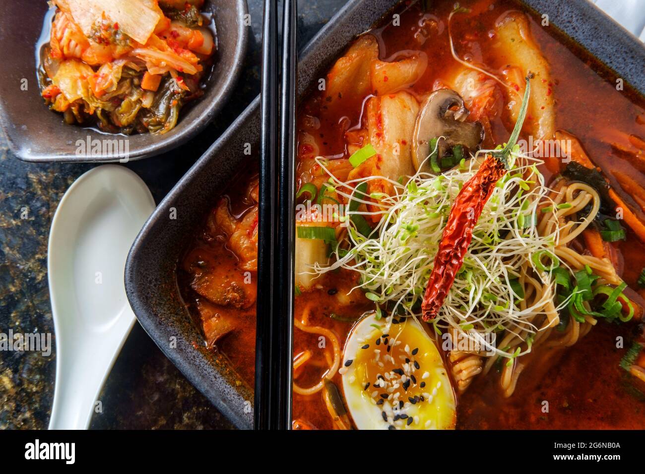 Korean kimchi ramen garnished with mushrooms scallions and a softboiled