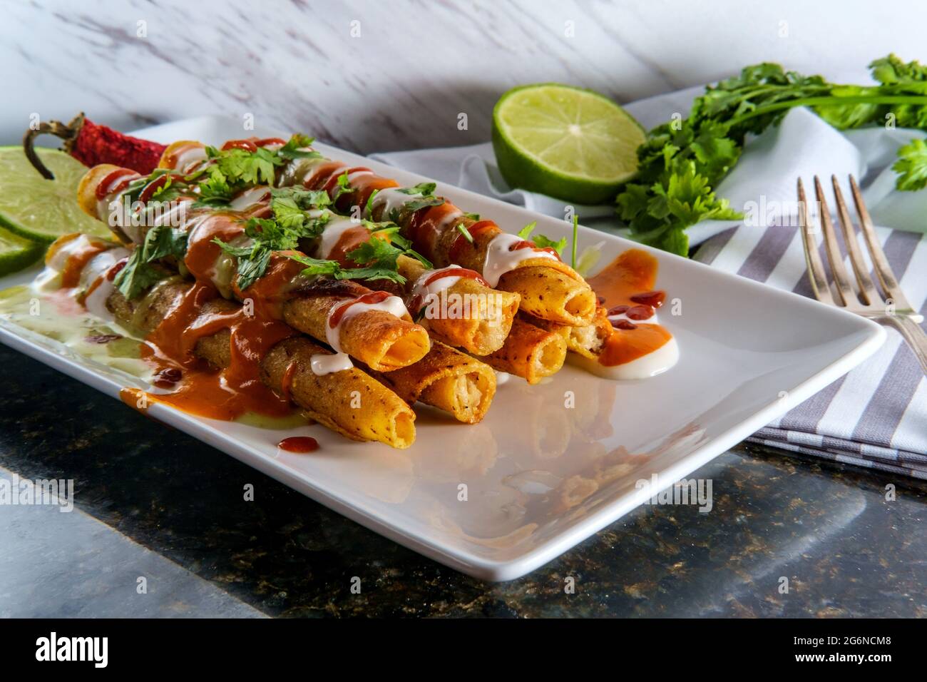 Mexican chicken and cheese rolled taco taquitos smothered in hot sauces