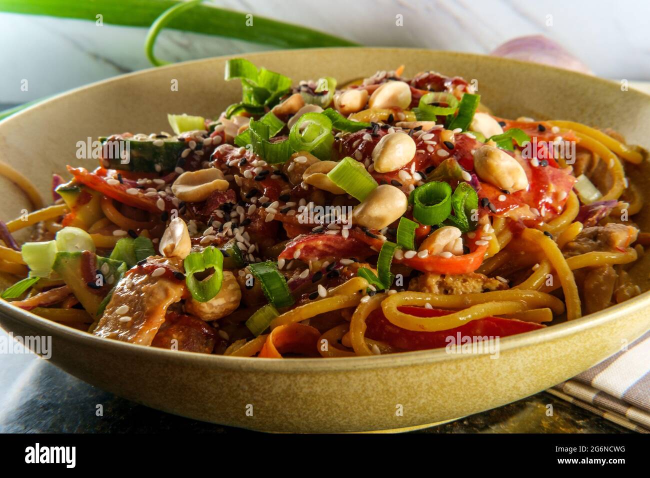 Spicy Thai chicken peanut butter lo mein noodles with tuxedo sesame