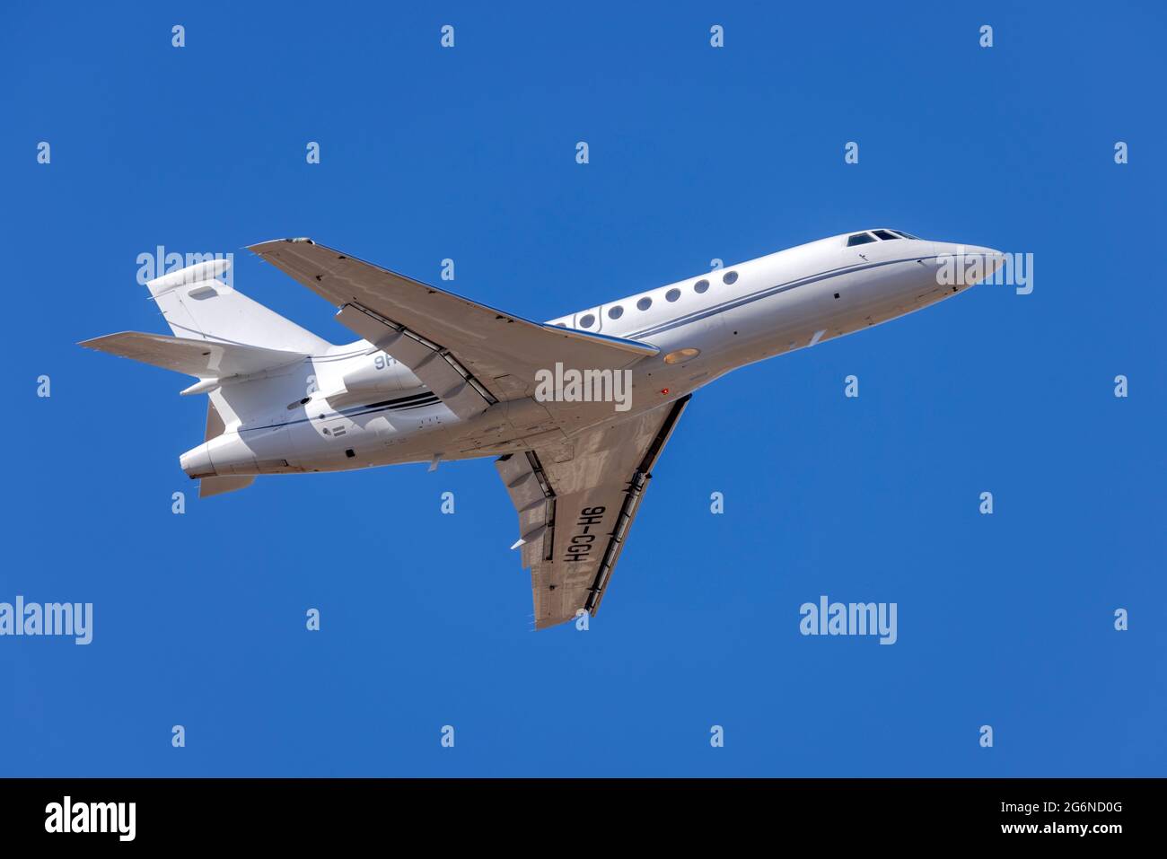Dassault Falcon 50EX REG: 9H-CGH climbing out of runway 13. Stock Photo