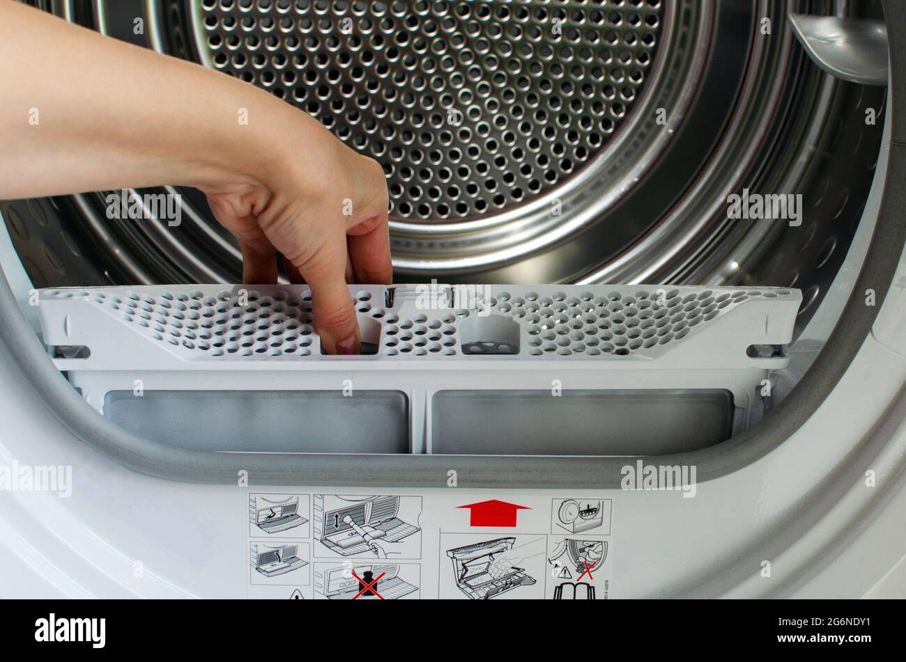 https://c8.alamy.com/comp/2G6NDY1/a-housewife-holds-a-lint-trap-from-a-front-loading-dryer-a-womans-hand-took-out-the-filter-from-the-dryer-2G6NDY1.jpg