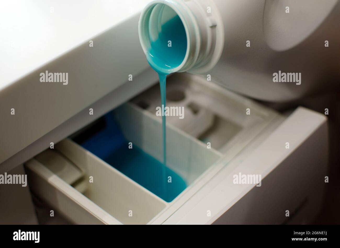 pour gel for washing into washing machine, white bottle with blue gel