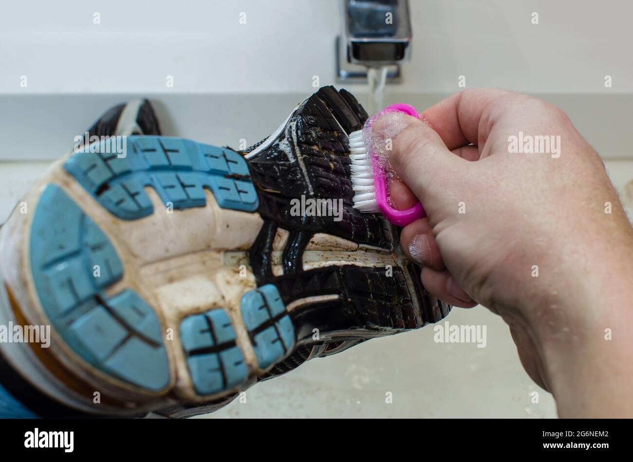 Cleaning dirty sneakers after training. Wash dirty sneakers. Wash your