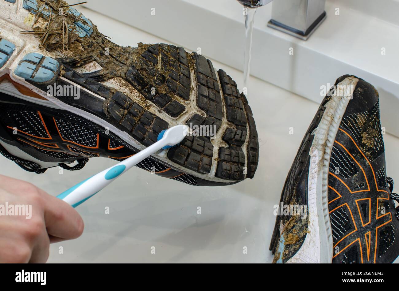 Cleaning dirty sneakers after training. Wash dirty sneakers. Wash your