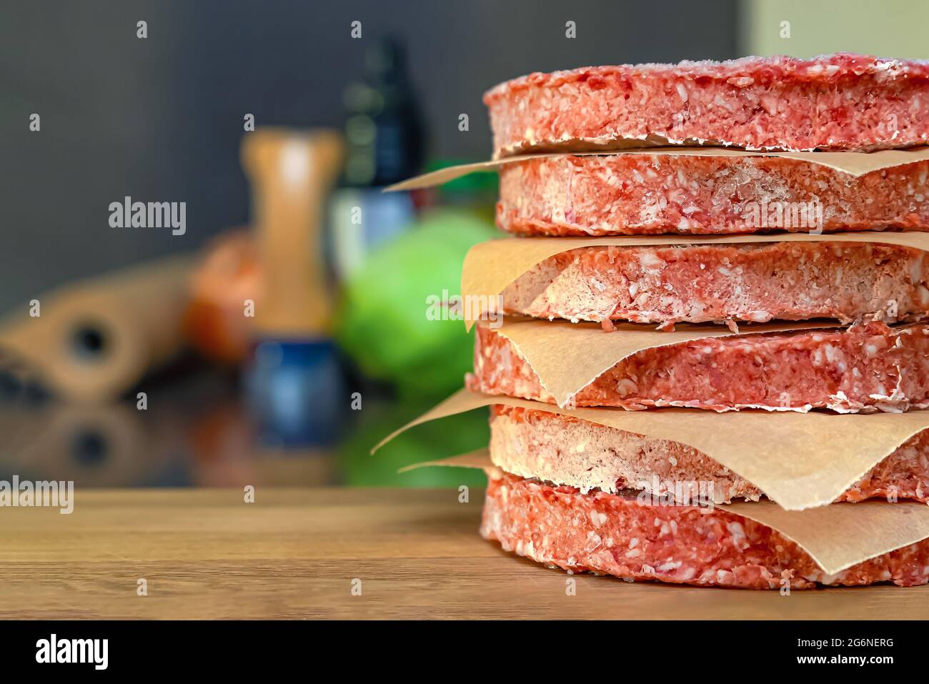 frozen beef hamburger patties, defrost before grilling, stacked on the