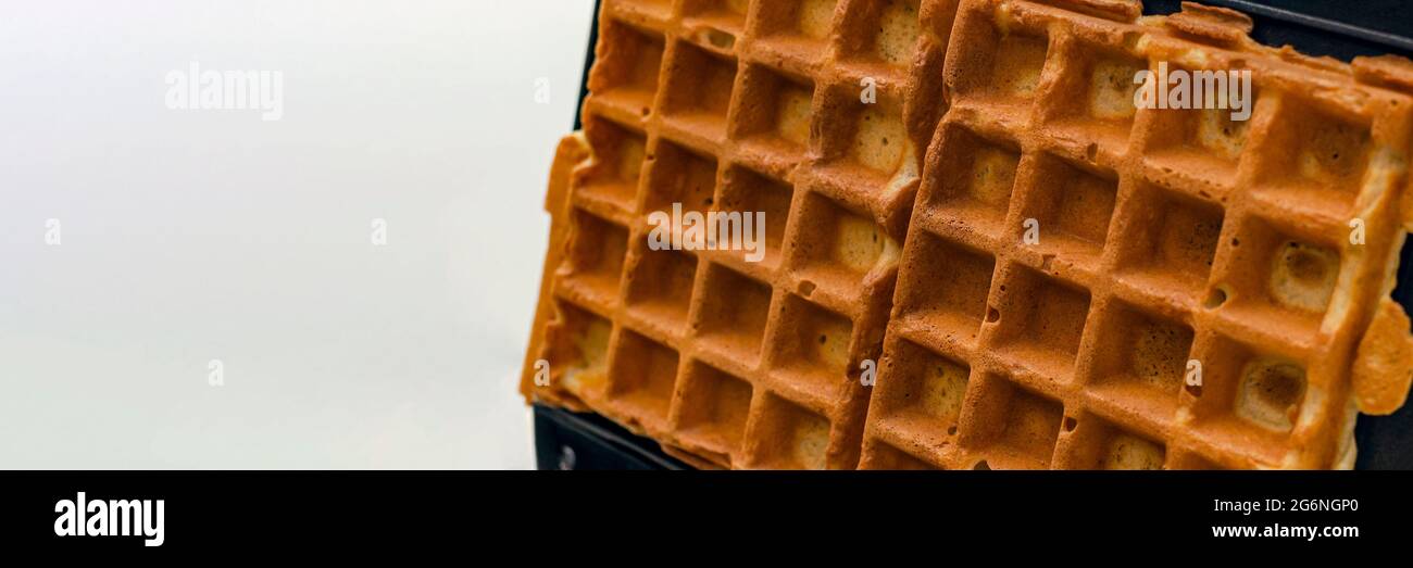 Modern waffle maker with ingredients, homemade Belgian waffles Stock