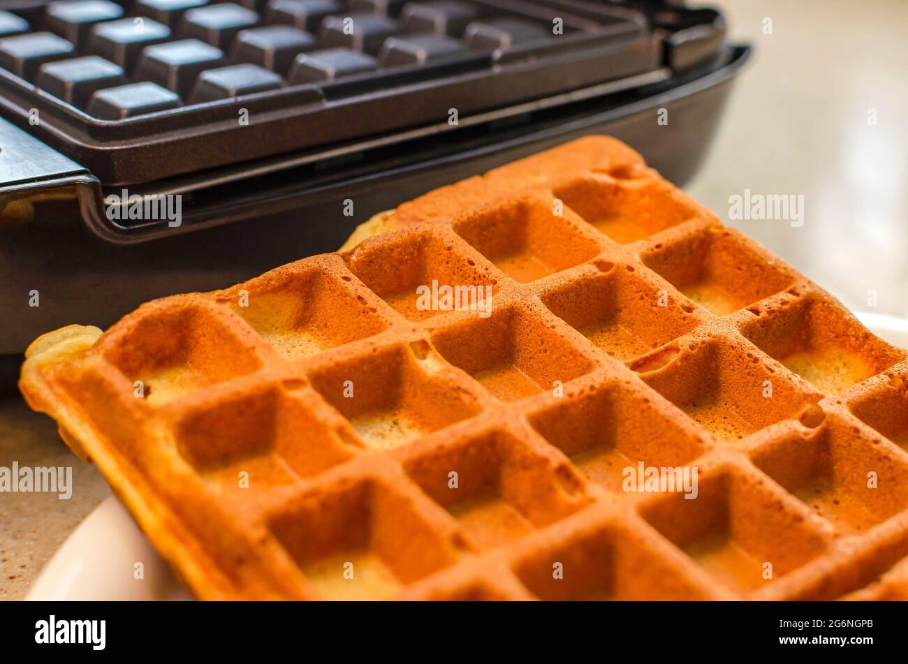Modern waffle maker with ingredients, homemade Belgian waffles Stock