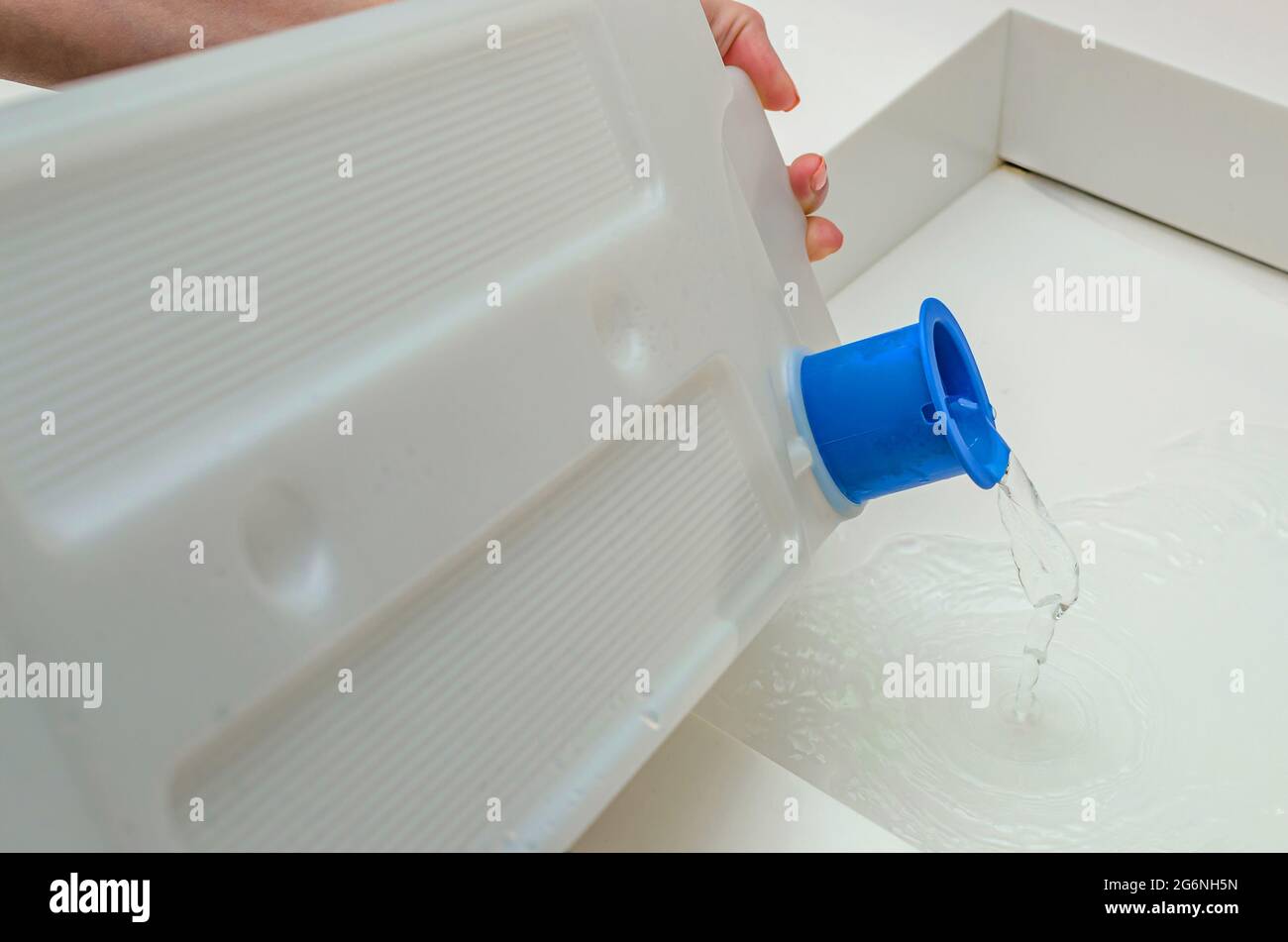 Condensate container from the dryer, a woman drains the accumulated