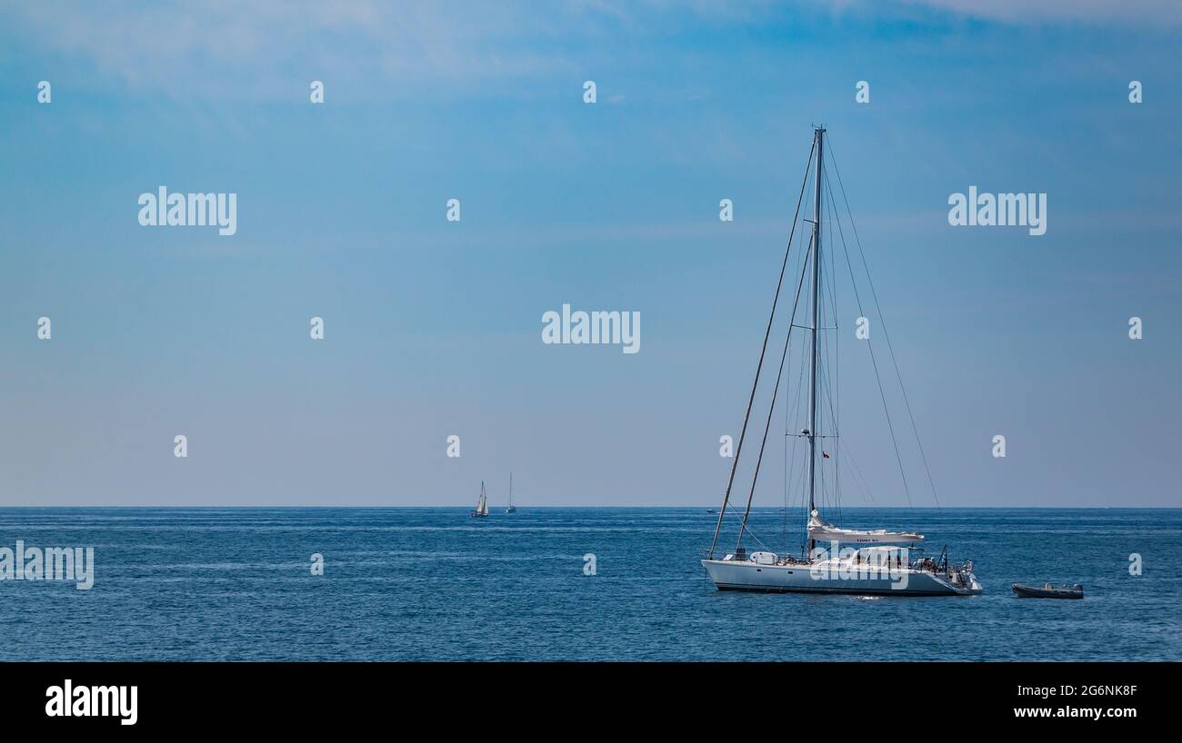 A picture of a sailing boat alone in the Mediterranean Sea Stock Photo ...