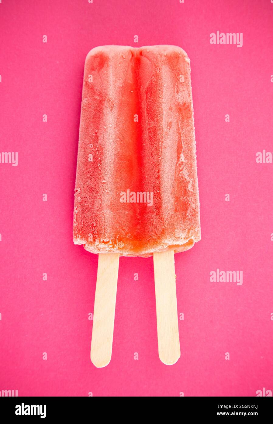 Red Popsicle on a Bright Pink Background Stock Photo - Alamy