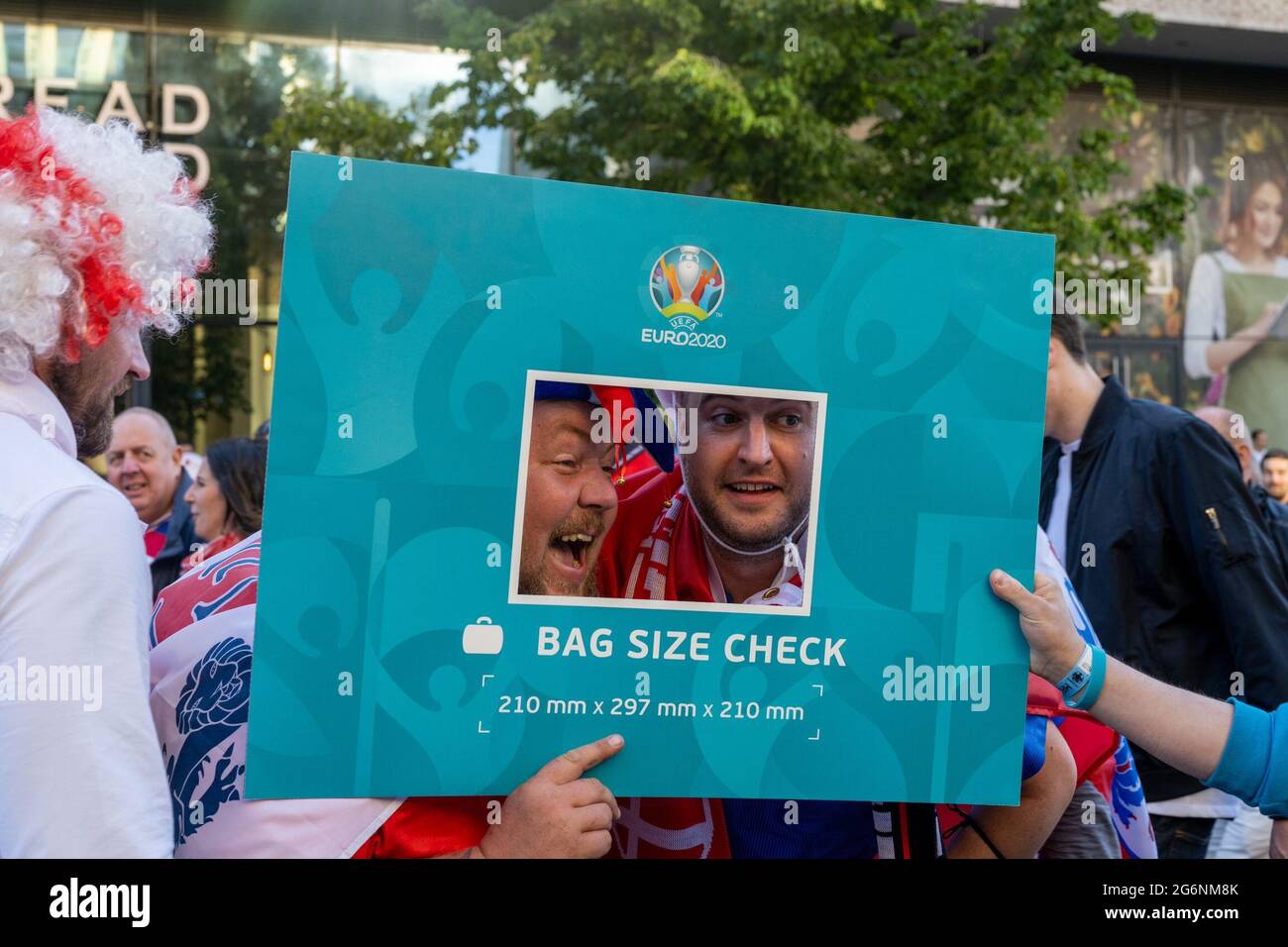 London, UK. 7th July 2021. England fans use the Euro 2020 bag sizer as a selfie frame. Credit: Thomas Eddy/Alamy Live News Stock Photo