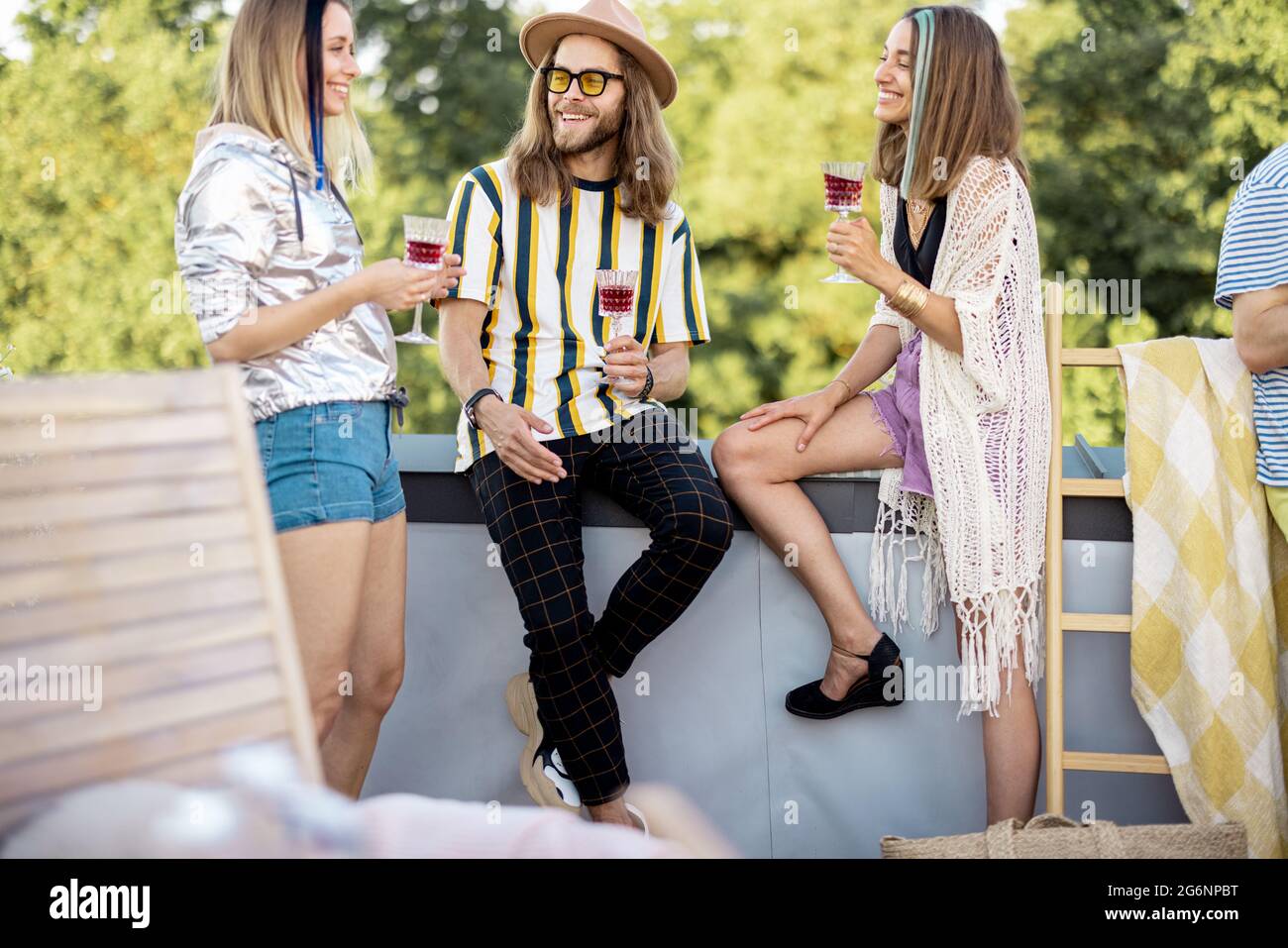 Friends hanging out at picnic outdoors Stock Photo