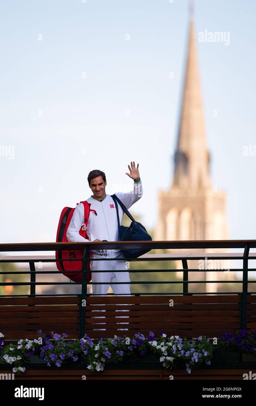 Roger Federer walks across the players bridge on day nine of Wimbledon at The All England Lawn